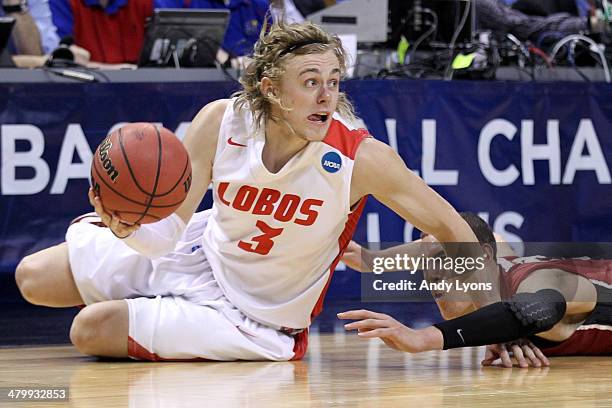 Hugh Greenwood of the New Mexico Lobos slides to grab a loose ball against Dwight Powell of the Stanford Cardinal in the second half during the...