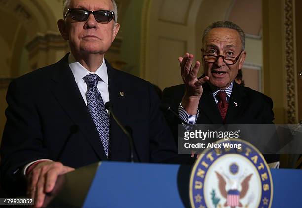 Sen. Charles Schumer speaks as Senate Minority Leader Sen. Harry Reid listens during a news briefing July 8, 2015 at the U.S. Capitol in Washington,...