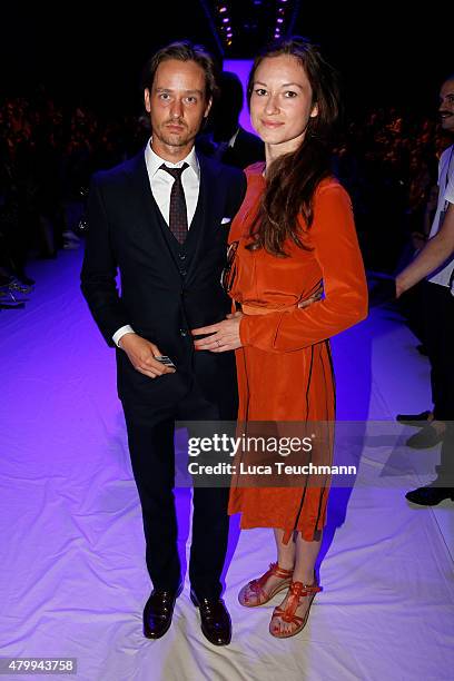 Tom Schilling and Annie Mosebach attend the Esther Perbandt show during the Mercedes-Benz Fashion Week Berlin Spring/Summer 2016 at Brandenburg Gate...