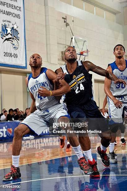 Kammeon Holsey of the Detroit Pistons and Romero Osby of the Indiana Pacers battle for the rebound on July 8, 2015 at Amway Center in Orlando,...