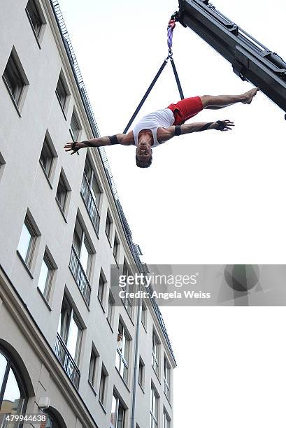 Aerialist Thomas Seitel performs at the Ben Weide Performance & Party during the Mercedes-Benz Fashion Week Berlin Spring/Summer 2016 at Ben Weide...