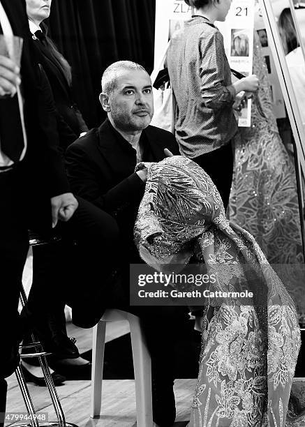 Designer Elie Saab works backstage before his show as part of Paris Fashion Week Haute Couture Fall/Winter 2015/2016 on July 8, 2015 in Paris, France.