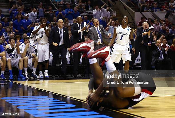 Austin Chatman and the Creighton Bluejays bench celebrate after a play as Bryant Mbamalu of the Louisiana Lafayette Ragin Cajuns lies on the court in...
