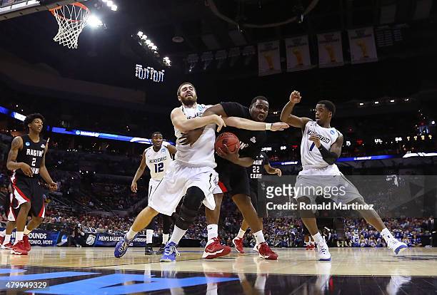 Davenport of the Louisiana Lafayette Ragin Cajuns fights for the ball with Ethan Wragge of the Creighton Bluejays in the second half during the...