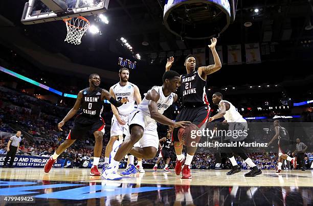 Austin Chatman of the Creighton Bluejays handles the ball against Shawn Long of the Louisiana Lafayette Ragin Cajuns in the second half during the...