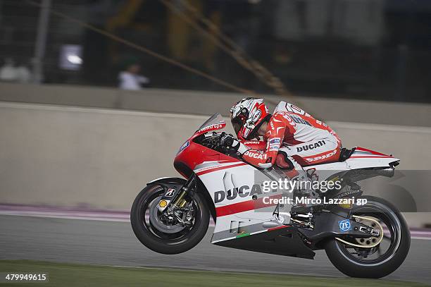 Andrea Dovizioso of Italy and Ducati Team lifts the front wheel during the MotoGp of Qatar - Free Practice at Losail Circuit on March 21, 2014 in...