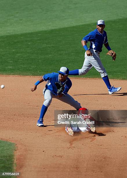 Roger Bernadina of the Cincinnati Reds steals second base before the tag of Humberto Arteaga of the Kansas City Royals at Goodyear Ballpark on March...