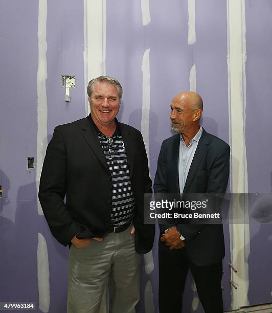 General manager Garth Snow and former New York Islanders player Bob Nystrom meet up during a tour of the new facilities prior to the 2015 New York...