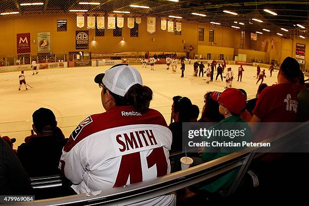 Fans watch as Arizona Coyotes propects participant in the development camp at the Ice Den on July 8, 2015 in Scottsdale, Arizona.