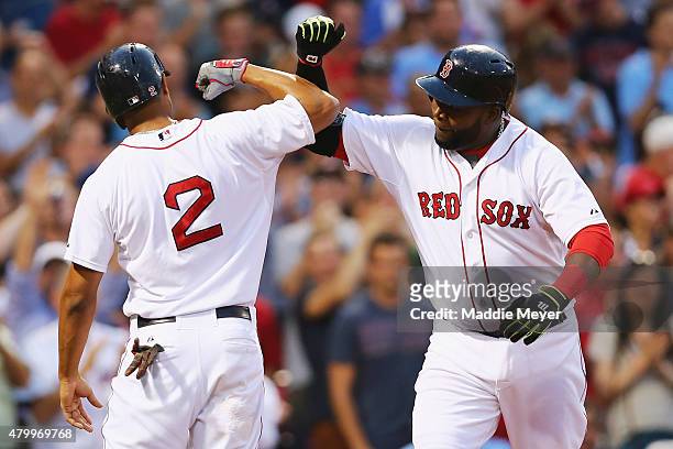 David Ortiz of the Boston Red Sox celebrates with Xander Bogaerts after hitting a two run homer during the third inning against the Miami Marlins at...