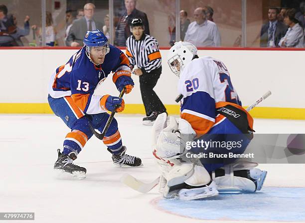 Anthony Pupplo stops Mathew Barzal in the 2015 New York Islanders Blue & White Rookie Scrimmage & Skills Competition at the Barclays Center on July...