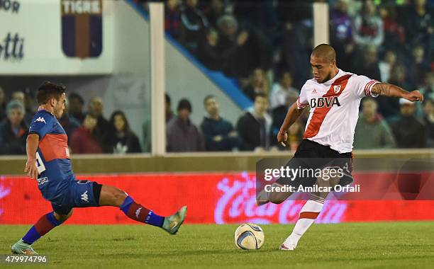 Jonathan Maidana of River Plate kicks the ball as Leandro Julian Garate of Tigre defends during a match between Tigre and River Plate as part of 13th...