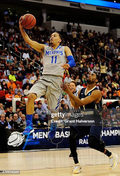 Michael Dixon Jr. #11 of the Memphis Tigers shoots against Maurice Creek of the George Washington Colonials in the second half during the Second...