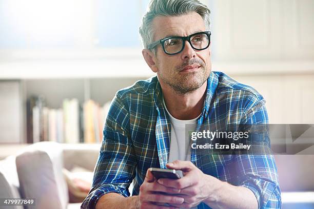 thoughtful man relaxing at home. - 中年の男性一人 ストックフォトと画像