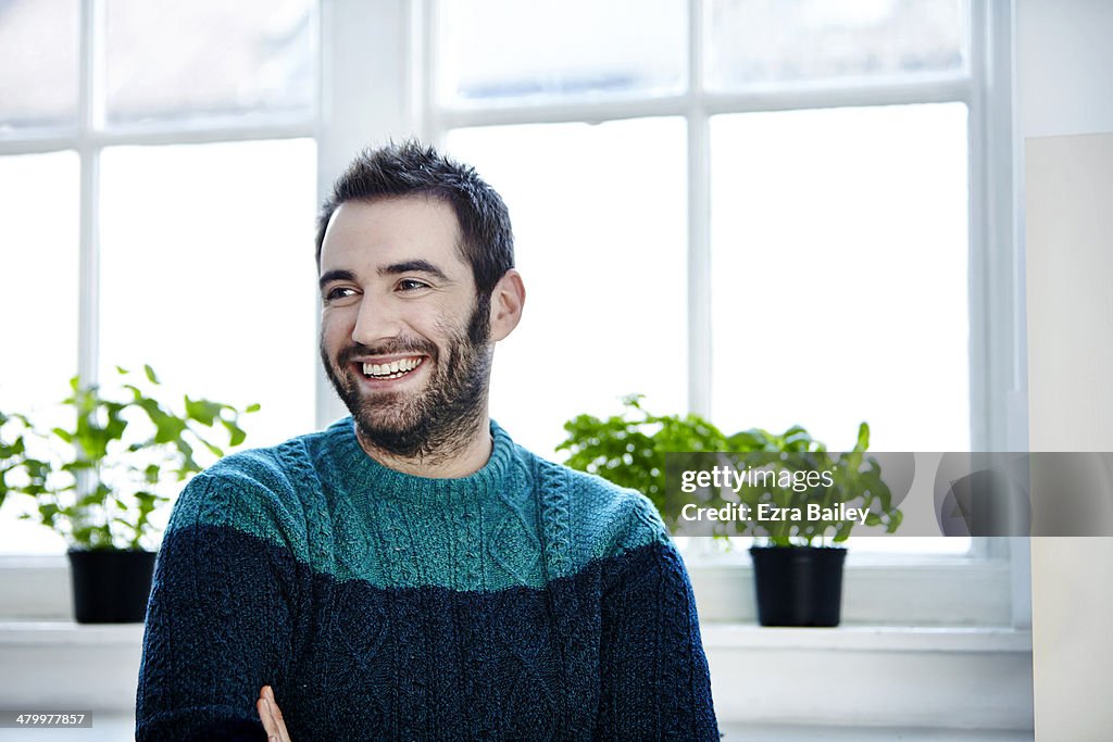 Portrait of a man surrounded by plants.