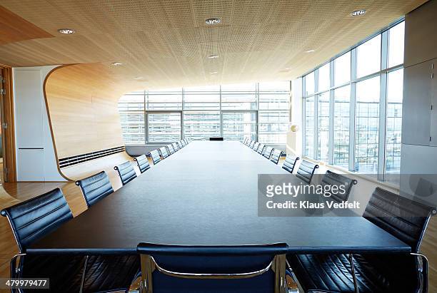 view over huge table in designed meeting room - board room stock-fotos und bilder