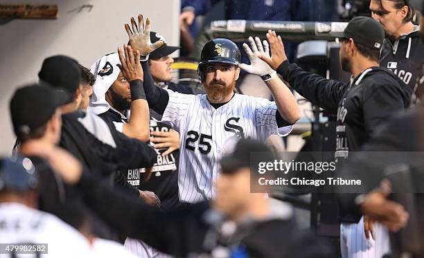 The Chicago White Sox's Adam LaRoche is congratulated by teammates after his two-run double in the first inning against the Toronto Blue Jays at U.S....