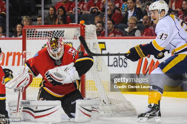 Joni Ortio of the Calgary Flames stops the shot of Colin Wilson of the Nashville Predators during an NHL game at Scotiabank Saddledome on March 21,...