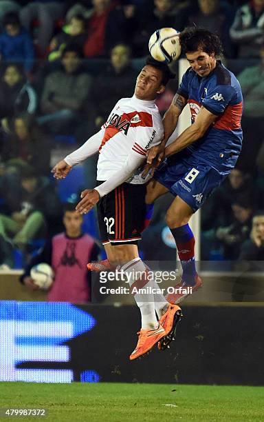 Sebastian Driussi of River Plate and Martín Galmarini of Tigre jump for a header during a match between Tigre and River Plate as part of 13th round...