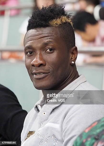 Ghana's striker Asamoah Gyan watches from the stand during the 2015 CFA Cup between Shanghai SIPG FC and Guangzhou R&F FC at Shanghai Stadium on July...