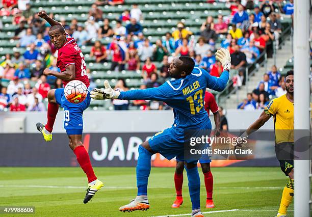 Roy Miller of Costa Rica scores a goal as Dwayne Miller of Jamaica attempt to stop the ball during the 2015 CONCACAF Gold Cup Group B match between...