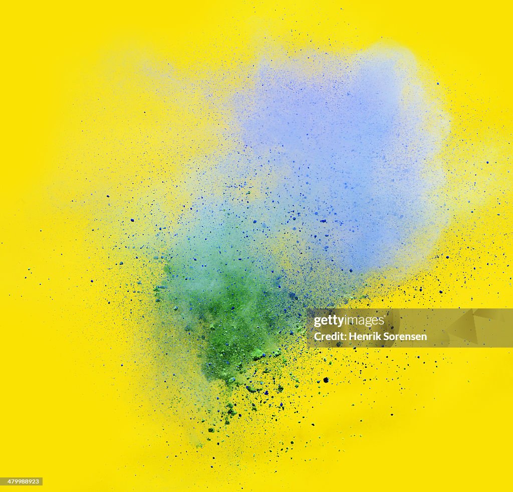 Explosion of colored powder, blue and green