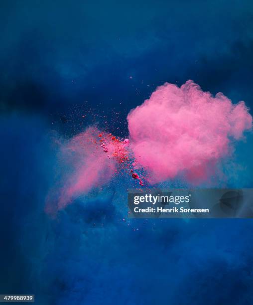 explosion of pink colored powder - powder explosion stock pictures, royalty-free photos & images
