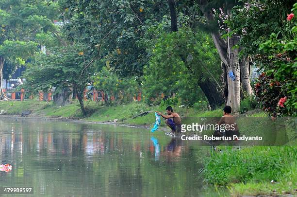 Indonesians wash their clothes in a polluted river on World Water Day March 22, 2014 in Surabaya, Indonesia. World Water Day recognizes the global...