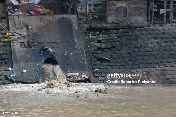 Man washes his clothes in a polluted river on World Water Day March 22, 2014 in Surabaya, Indonesia. World Water Day recognizes the global need for...