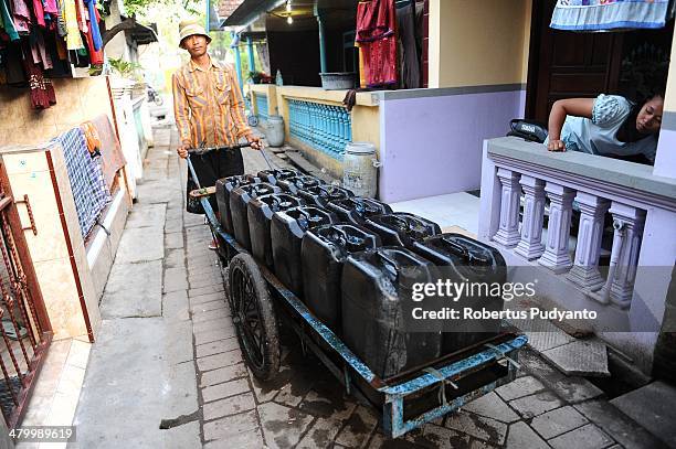 Man peddles clean water on World Water Day March 22, 2014 in Surabaya, Indonesia. World Water Day recognizes the global need for water and energy...