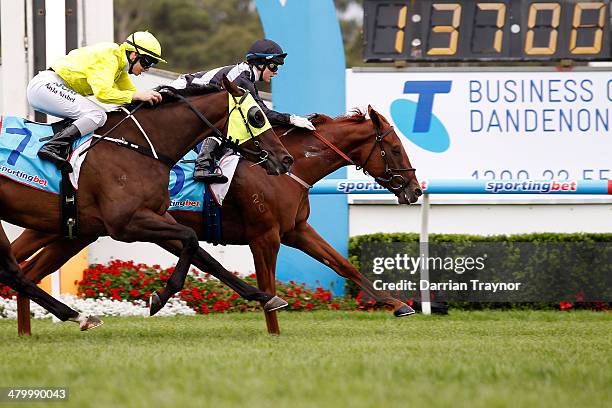 Jackie Beriman riding Written wins race 4 the Telstra Business Centre Dandenong Handicap ahead of Kayla Nisbet riding Arctic Song during City of...