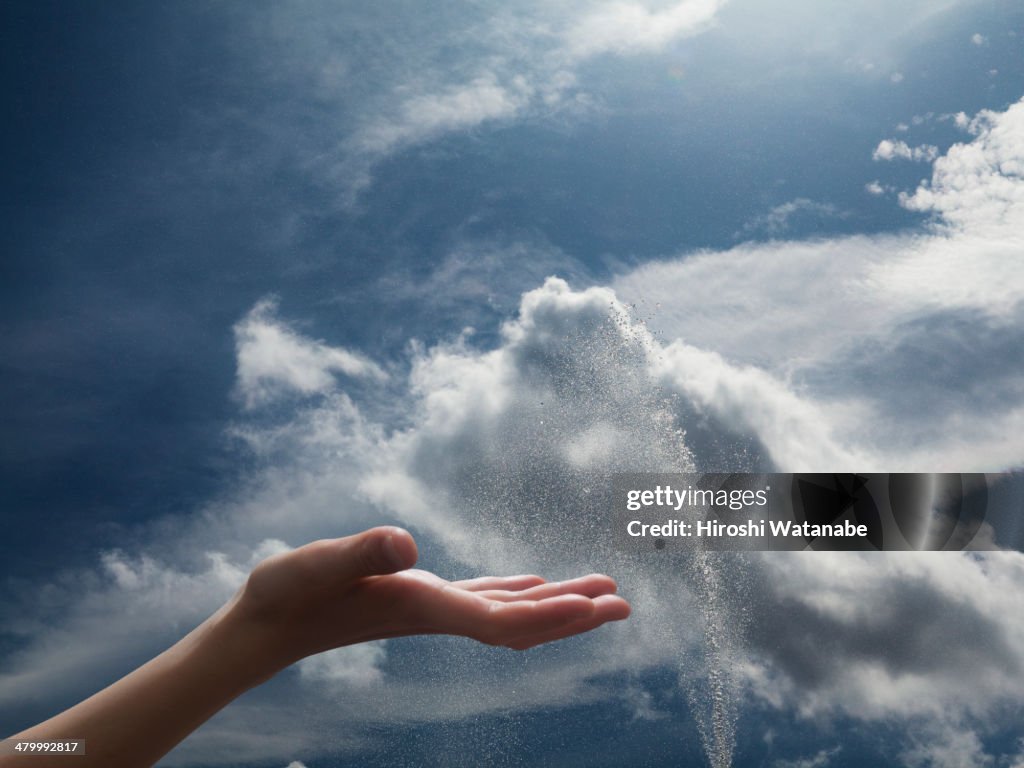 Hand of girl in the sky with fountain