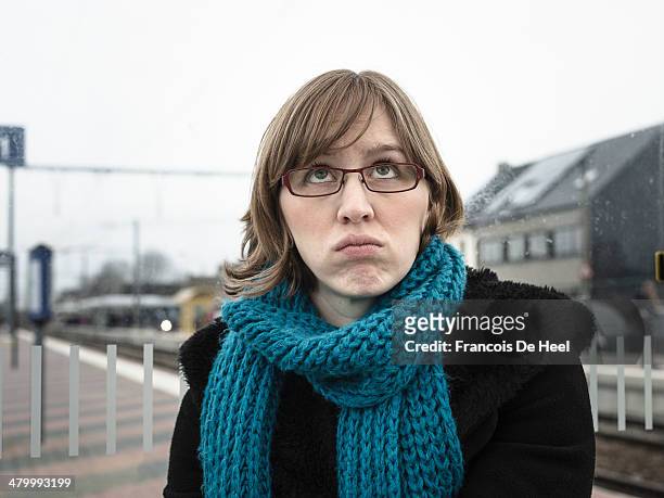 red haired young woman at a small train station - details geel stock pictures, royalty-free photos & images