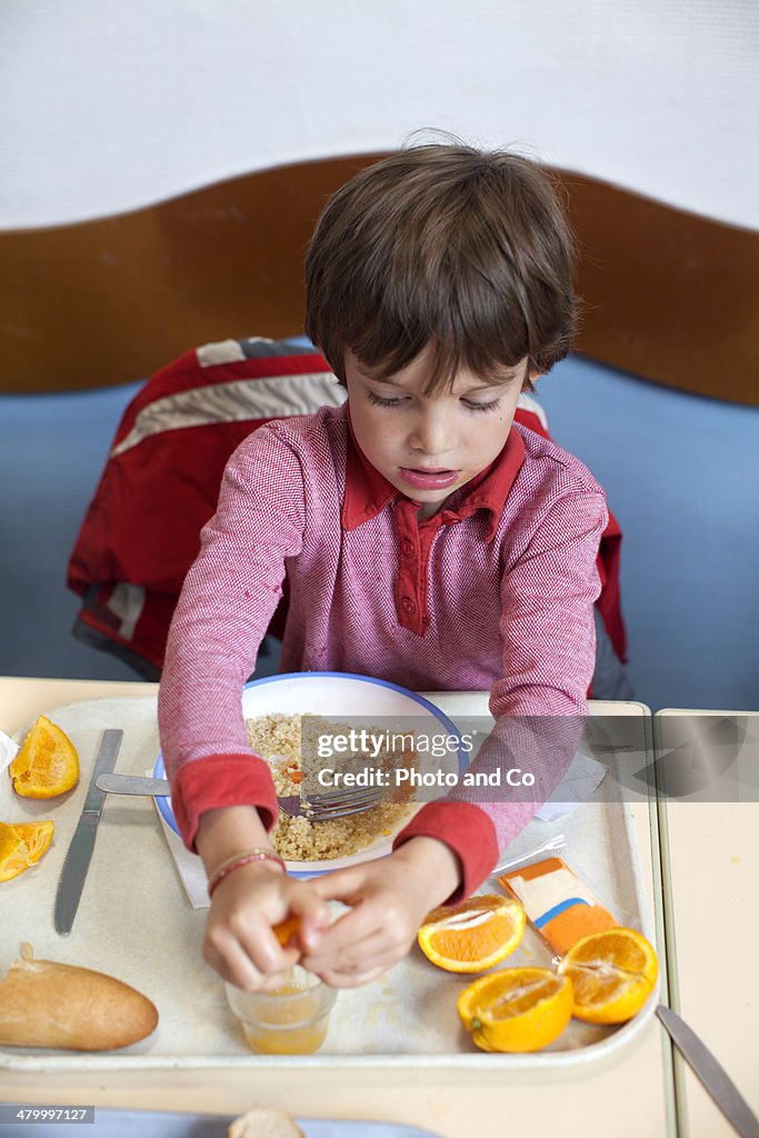 Boy with lunch tray  in school lunchroom