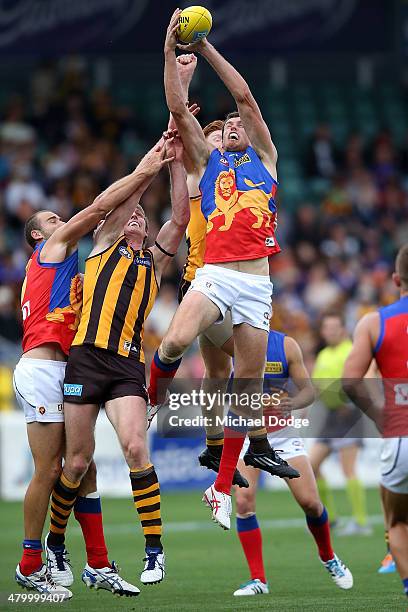 Matthew Leuenberger of the Lions marks the ball against David Hale of the Hawks during the round one AFL match between the Hawthorn Hawks and the...