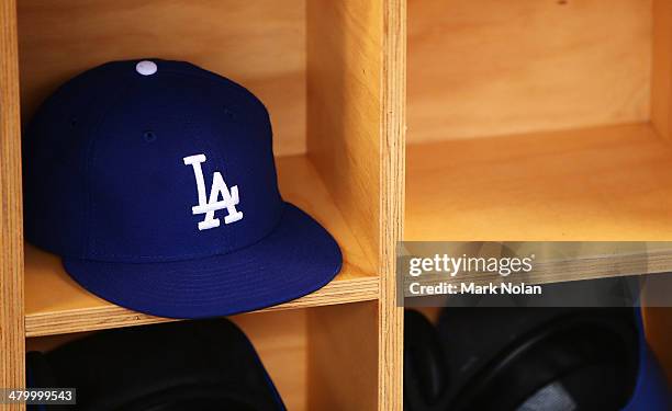 Dodgers cap is pictured in the dug out during the opening match of the MLB season between the Los Angeles Dodgers and the Arizona Diamondbacks at...