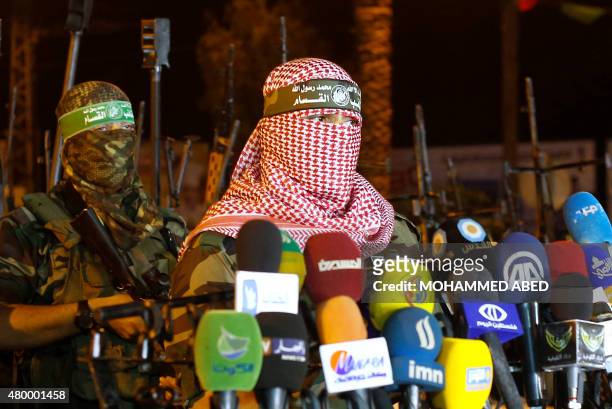 Palestinian Abu Obeida, spokesman of Hamas's armed wing, the Al-Qassam Brigades, delivers a statement in Gaza City late on July 8, 2015. Israel and...