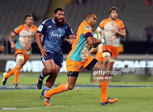 Central Cheetahs player Cornal Hendricks breaks away from Auckland Blues player Charlie Faumuina during the Super 15 rugby match between the Auckland...