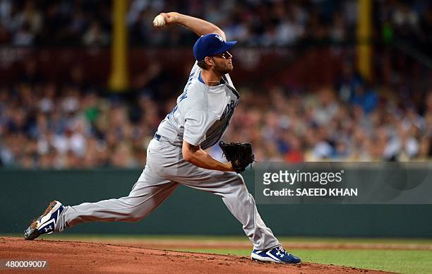 Clayton Kershaw of the Los Angeles Dodgers pitches at the start of the Major League Baseball opening season game between the Los Angeles Dodgers and...