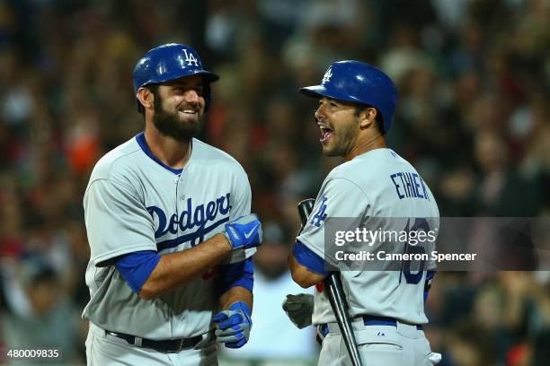 Andre Ethier of the Dodgers congratulates team mate Scott Van Slyke after hitting a home run during the opening match of the MLB season between the...