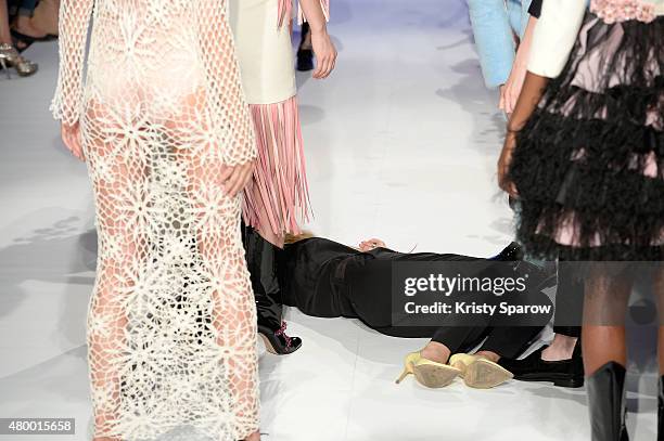 Designer Svetlana Kushnerova collapses during the finale of her show as part of Paris Fashion Week Haute Couture Fall/Winter 2015/2016 at Espace...