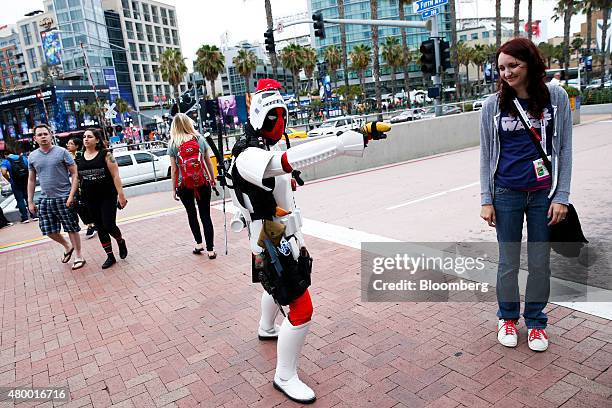 Myke Soler poses while dressed as the Marvel Comics character Deadpool wearing an Imperial Stormtrooper costume from the Star Wars franchise, left,...