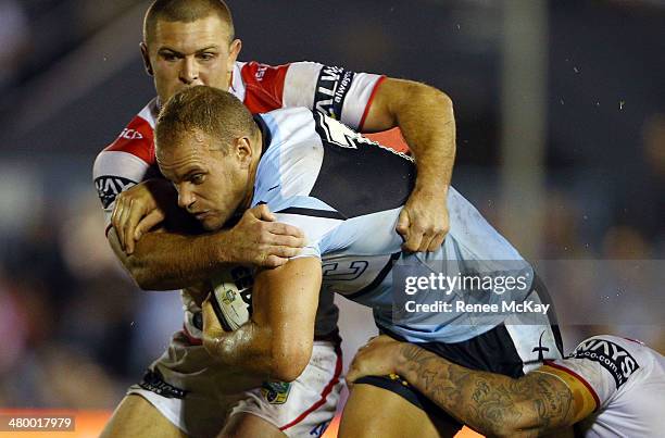 Daniel Holdsworth of the Sharks is tackled by Mitch Rein during the round three NRL match between the Cronulla-Sutherland Sharks and the St George...