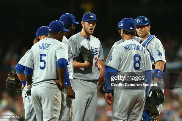 Dodgers Manager Don Mattingly talks to Dodgers pitcher Clayton Kershaw and team mates during the opening match of the MLB season between the Los...