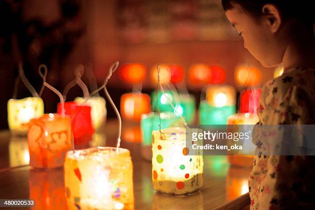 a kid is gazing at many handmade lanterns - festival tanabata fotografías e imágenes de stock