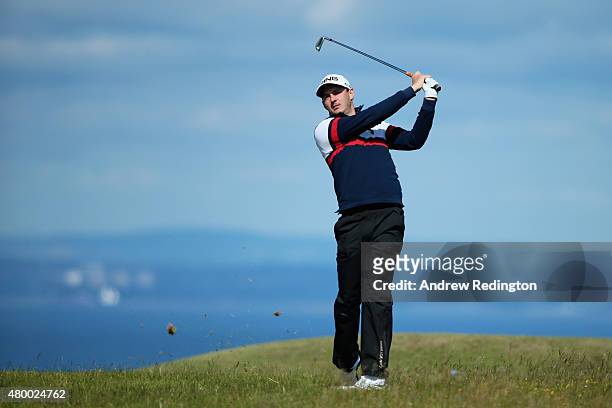 Matthew Nixon of England hits his second shot on the 13th hole during the first round of the Aberdeen Asset Management Scottish Open at Gullane Golf...