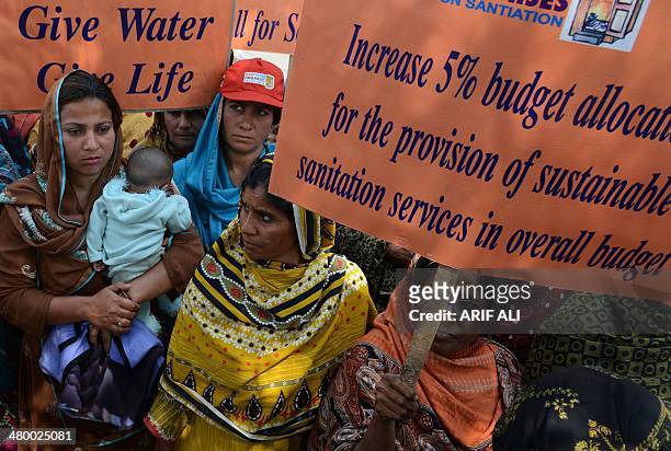 Pakistani demonstrators carry posters as they take part in a march to mark World Water Day in Lahore on March 22, 2014. International World Water Day...