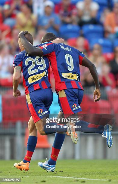 Joel Griffiths and Emile Heskey of the Jets celebrate a goal during the round 24 A-League match between the Newcastle Jets and Wellington Phoenix at...