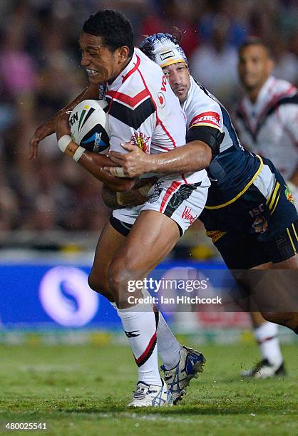 Jerome Ropati of the Warriors is tackled by Johnathan Thurston of the Cowboys during the round three NRL match between the North Queensland Cowboys...