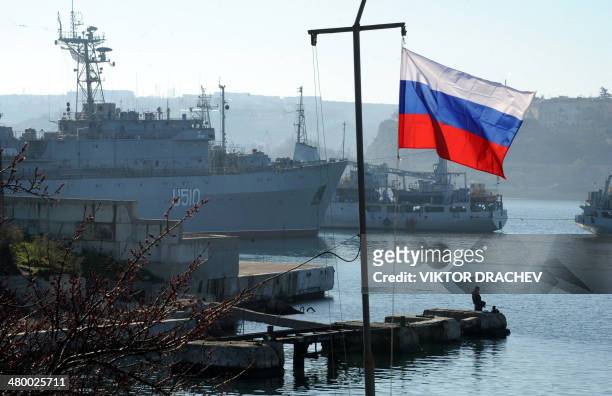 The Russian flag waves in front of the Ukrainian military ship the Slavutich moored in the bay of Sevastopol on March 22, 2014. About 200 pro-Russian...